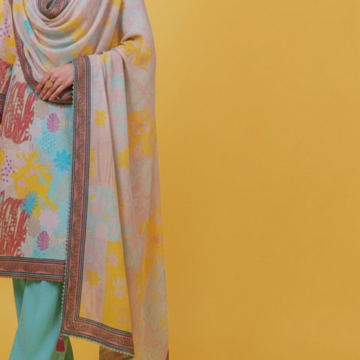 AllurifyYou three-piece ethnic suit set featuring a pastel floral print tunic, matching dupatta, and teal trousers.