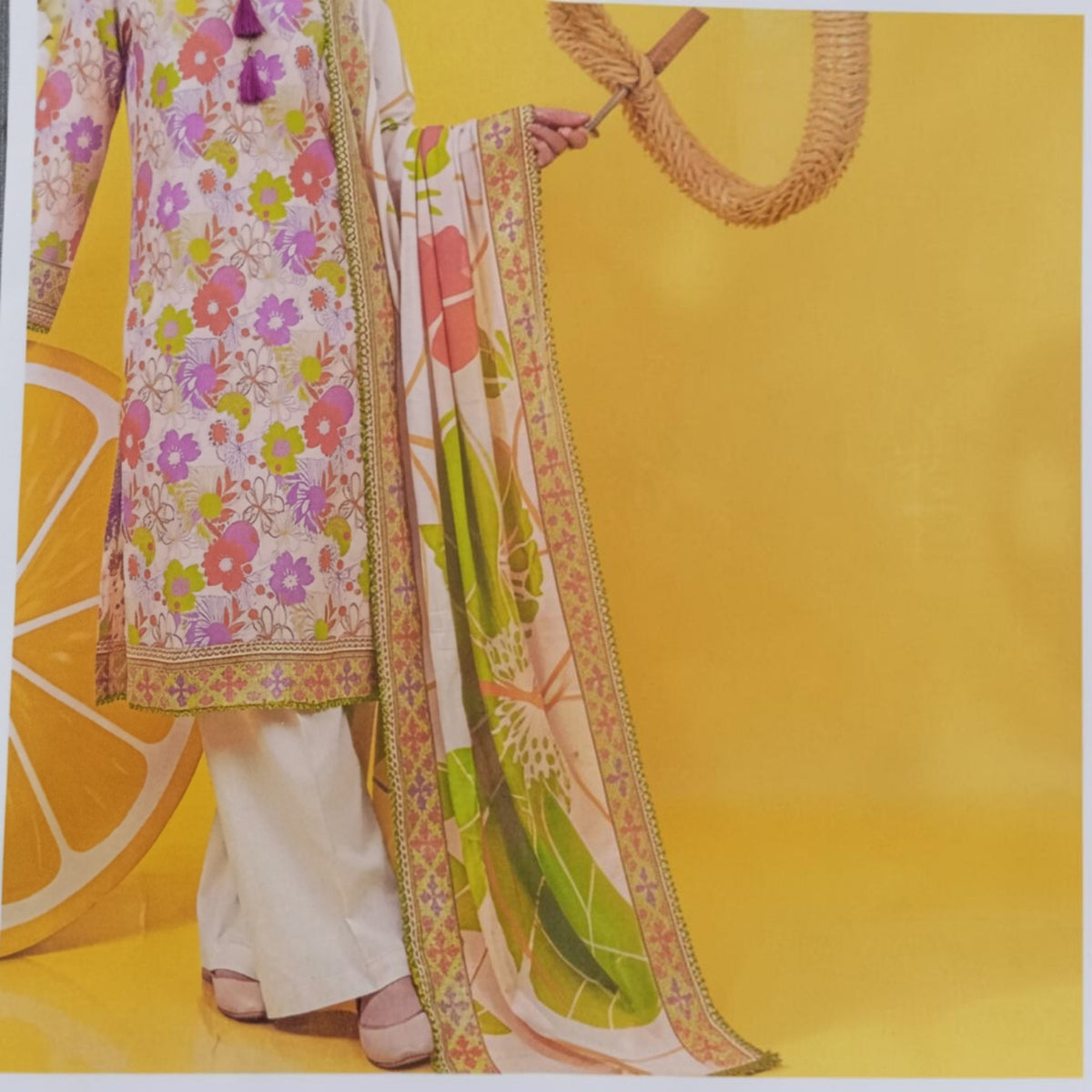 AllurifyYou three-piece lawn suit featuring a cream shirt with vibrant floral print, tassels, and matching dupatta.