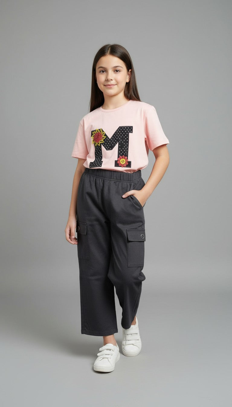 AllurifyYou girl wearing a pastel pink graphic t-shirt with sunflower detail and charcoal grey cargo trousers