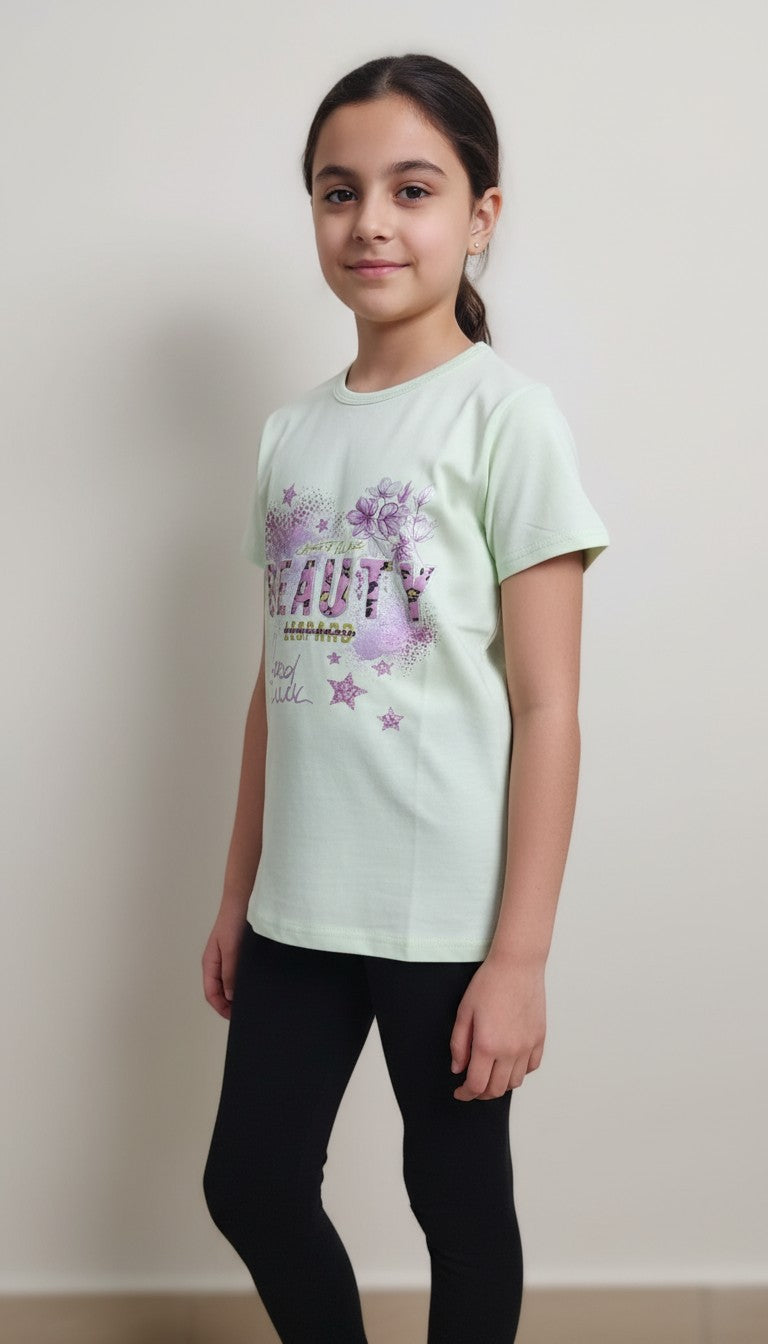 A young girl wearing an AllurifyYou mint green cotton t-shirt with a floral and star Beauty graphic print.