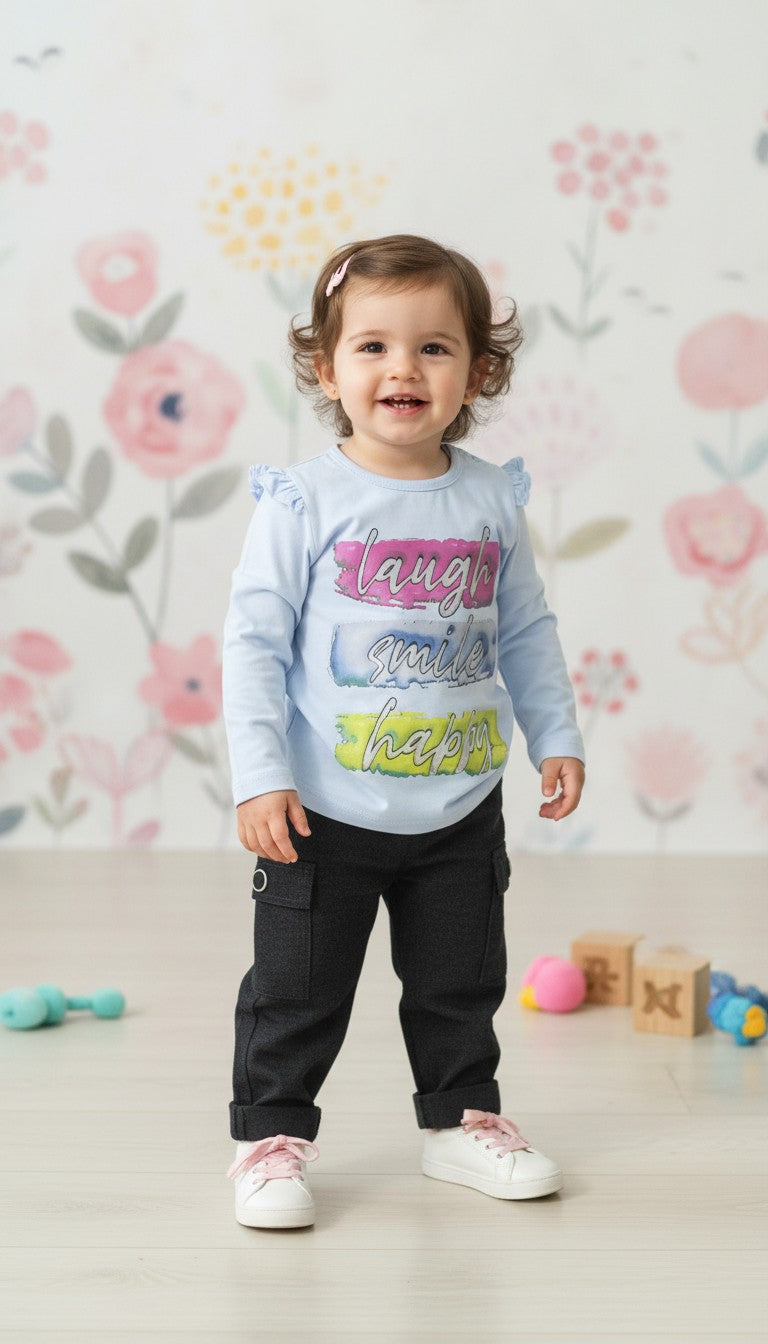 Toddler girl wearing an AllurifyYou pastel blue long-sleeve top with ruffle shoulders and black trousers